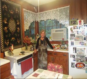 Dedra standing in her grandmother's kitchen.